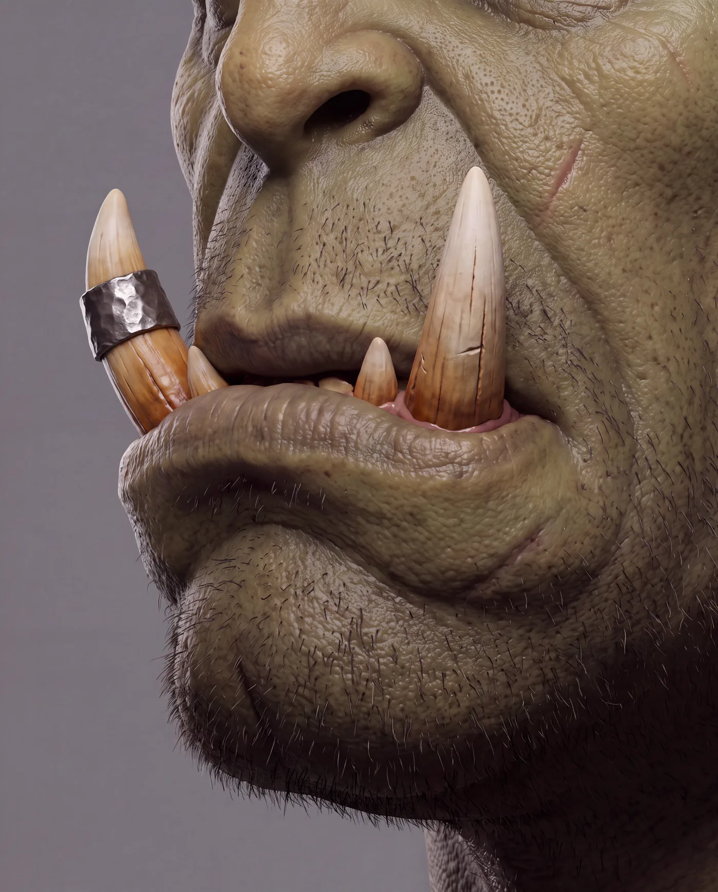 Macro of the orc's mouth and tusks, one tusk wrapped in a hammered silver band.
